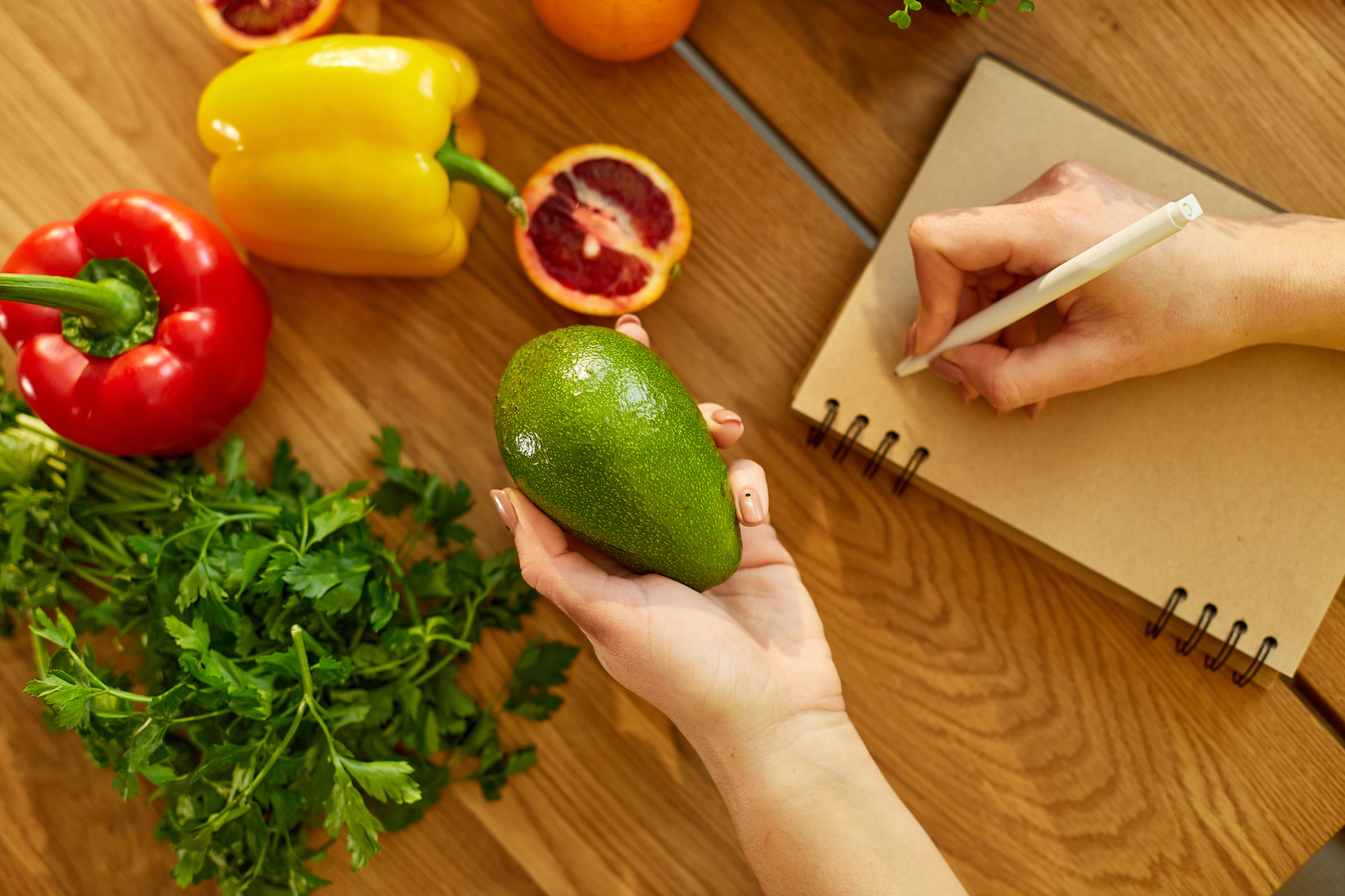 Person Writing Weekly Meals 